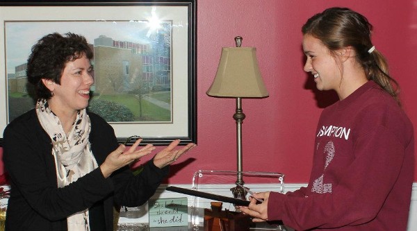Linda Maassen (l), chapter vice president for scholarships, presents a Lift Off Scholarship to Emily Carmack at her high school in April.